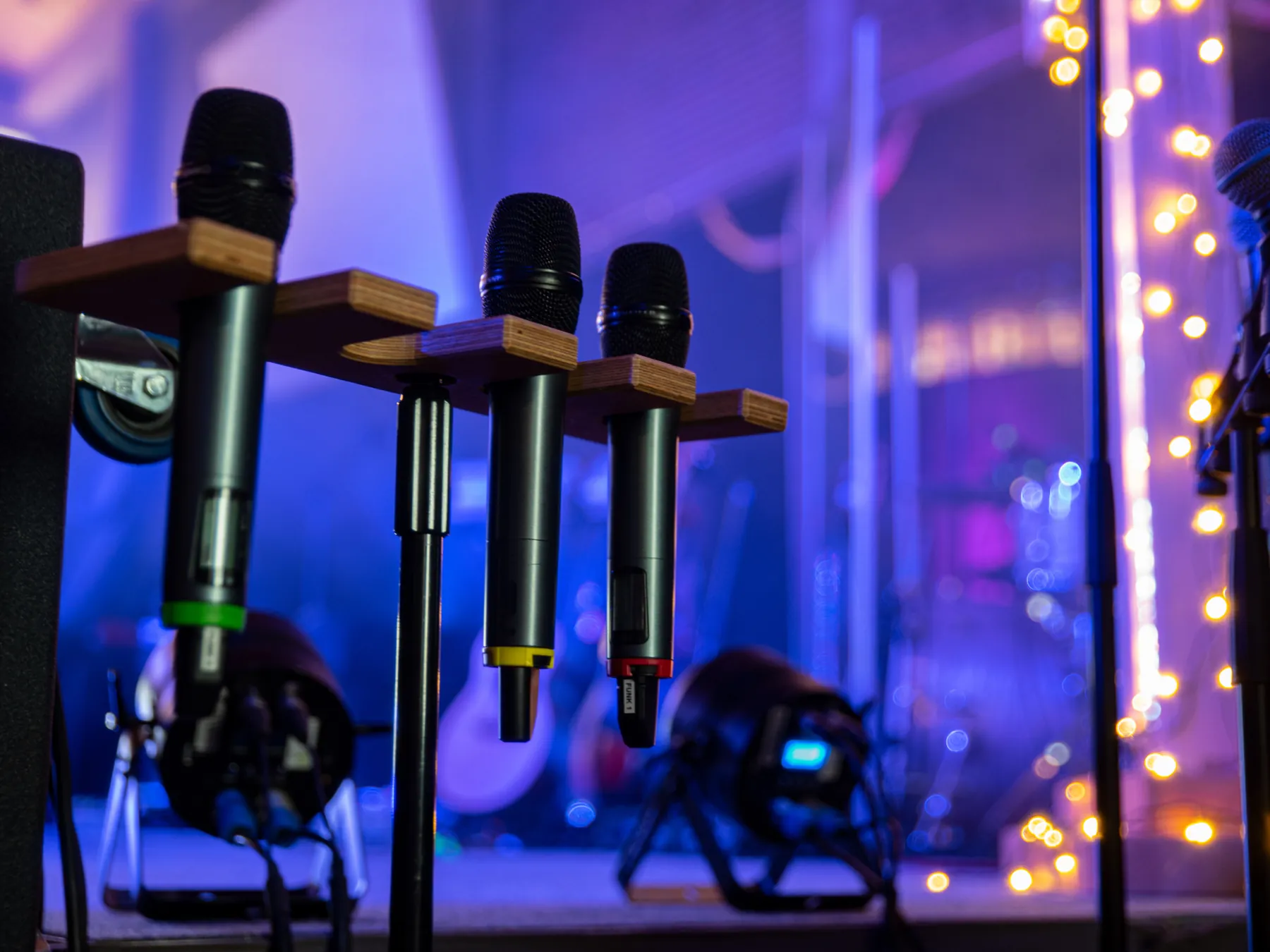 Wireless microphones staged under cool blue light.